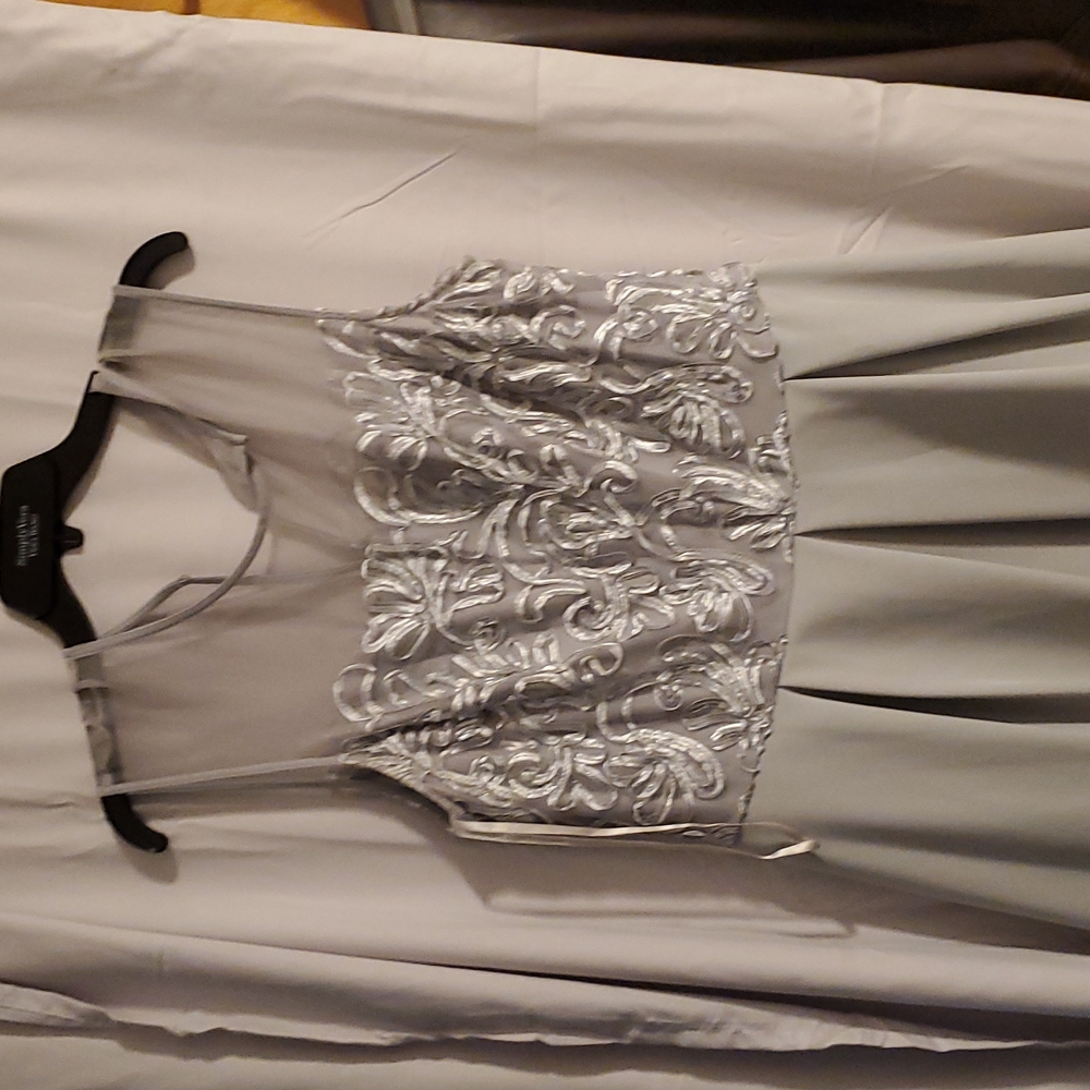 Grey aline dress with pleated skirt and sheer top with swirls